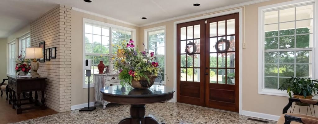 Bright entrance area with floral decorations and large windows