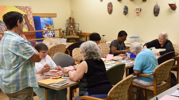 Residents engaging in a craft activity in a common area