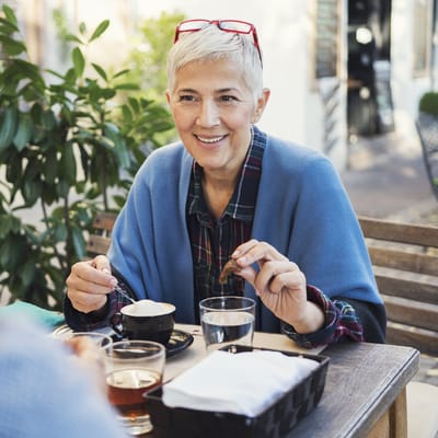 Senior woman enjoying coffee outdoors