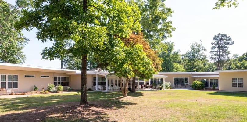 Exterior view of Southern Manor at Candler surrounded by trees