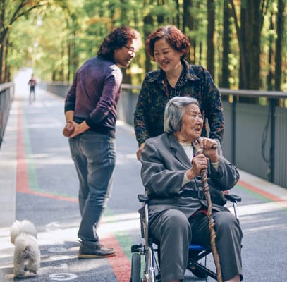Family members enjoying time outdoors with a senior