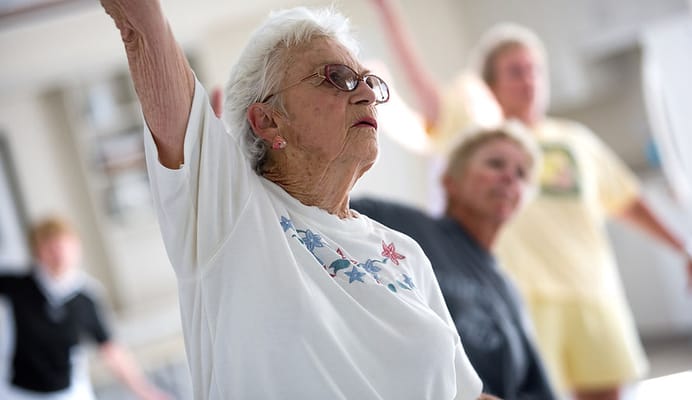 Senior woman participating in a group exercise class