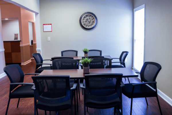 Bright, empty activity room with tables and chairs