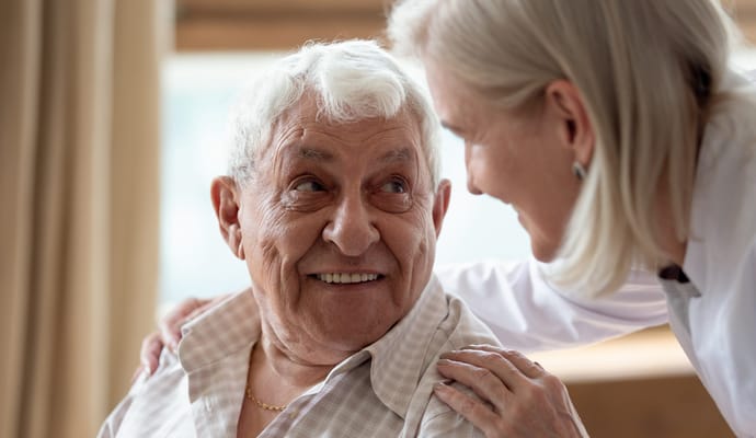 Care staff interacting with a smiling resident