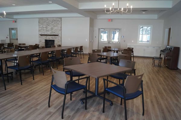 Bright common area with tables and chairs for events