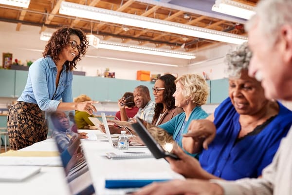 Residents engaging in a technology class with a staff member