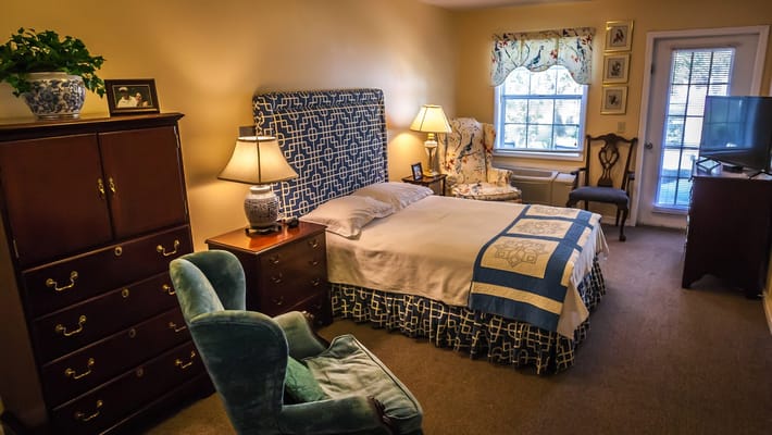 Cozy resident room with a bed and armchair