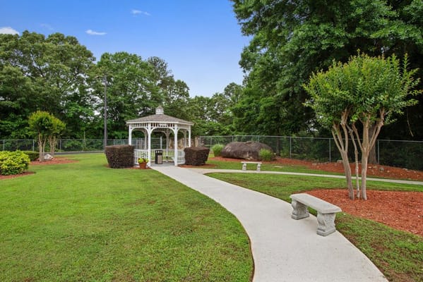 Pathway leading to a gazebo in green outdoor space