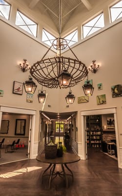 A well-lit interior space with a chandelier and seating area
