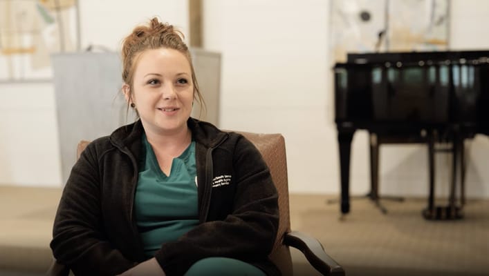 Staff member smiling in an activity room