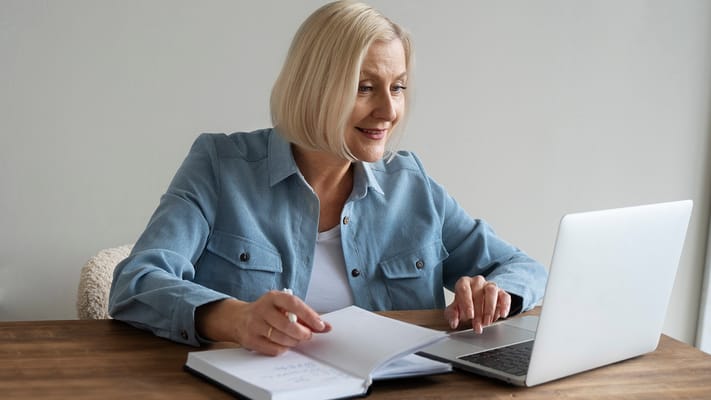 A senior resident using a laptop at a table