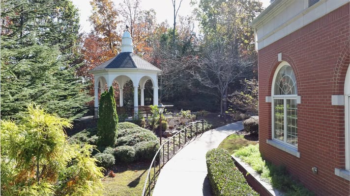 Outdoor gazebo surrounded by gardens