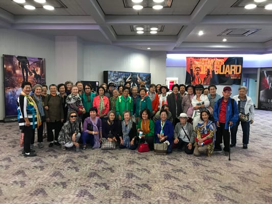 Group of residents posing in a common area at the facility