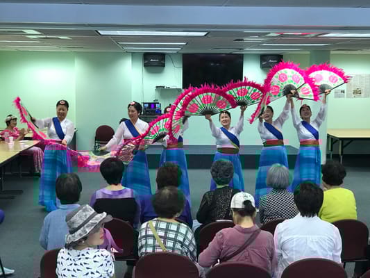 Residents enjoying a cultural performance in a common area