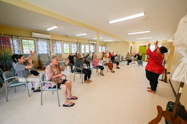 Residents participating in a seated exercise class