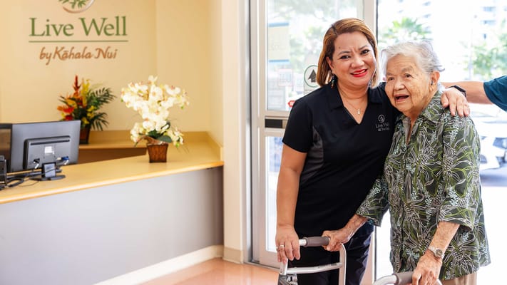 Staff assisting a resident in the facility lobby