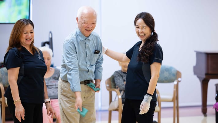 Residents participating in a group activity with staff
