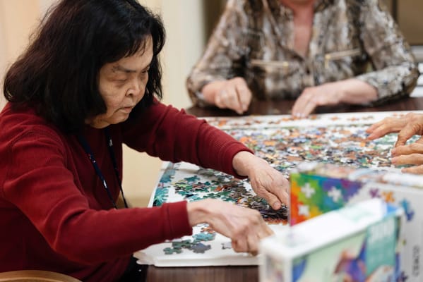 Residents enjoying a puzzle activity together