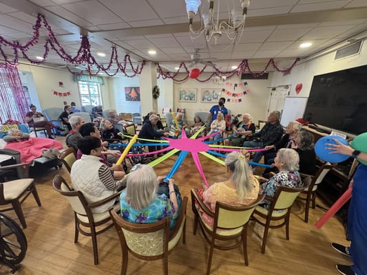 Residents engaged in a group activity with colorful props