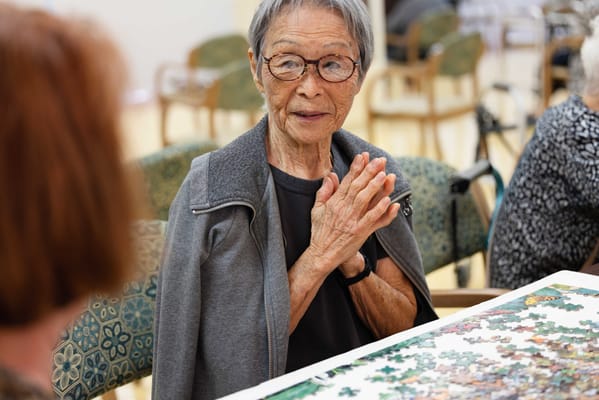 Resident engaged in a puzzle activity indoors