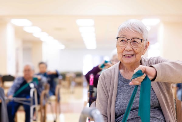 Elderly residents participating in an exercise class indoors