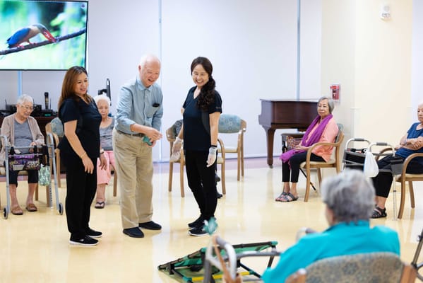 Residents and staff engaged in an activity indoors
