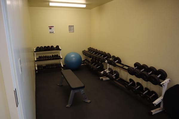 Interior gym space with weights and fitness equipment