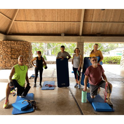 Residents participating in a group exercise activity outdoors