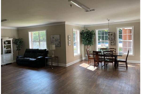 Bright common area with a dining table and seating