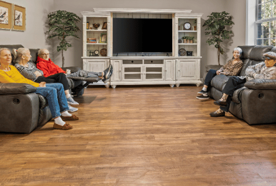 Residents sitting in a common area with comfortable seating