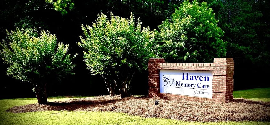 Sign for Haven Memory Care of Athens surrounded by trees