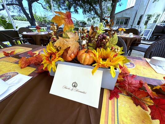 Decorative fall-themed table setting at an outdoor dining area