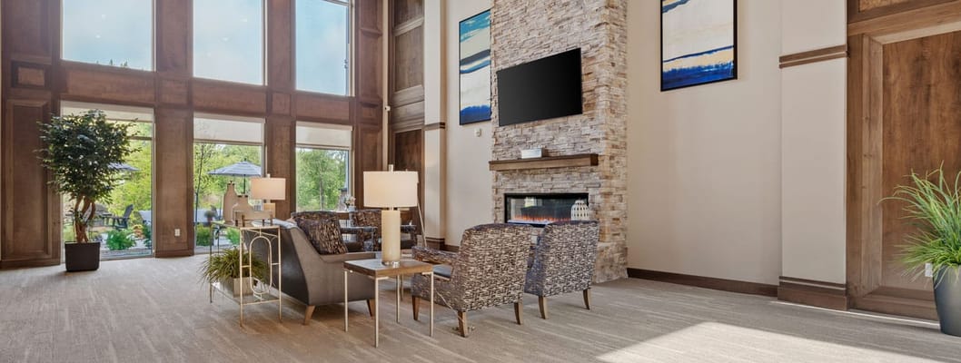 Bright common area with comfortable seating and a fireplace