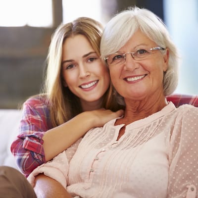 A woman and a senior resident smiling together
