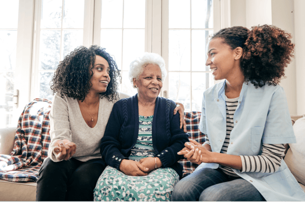 A caregiver and resident enjoying conversation in a bright interior.
