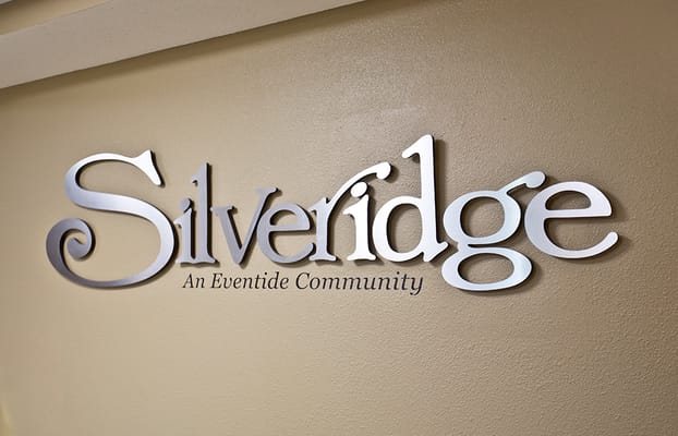 Facility logo on a beige wall