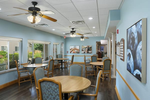 Dining area with tables and chairs in a bright interior