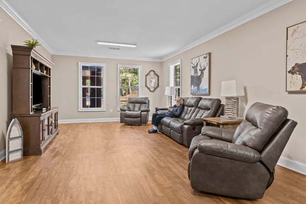 Residents enjoying a cozy common area with recliners