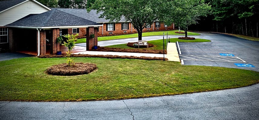 Exterior view of a senior care facility with landscaped area
