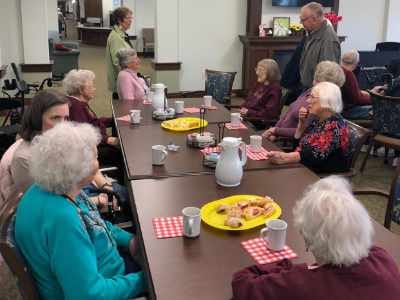 Residents enjoying a meal in a dining area