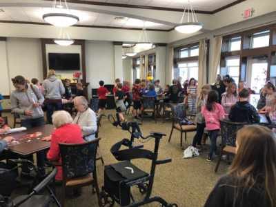 Residents and children engaging in a group activity in a common area