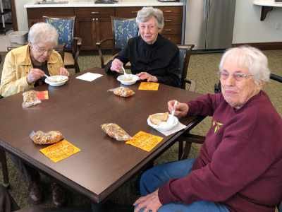 Residents enjoying a meal together at a communal table