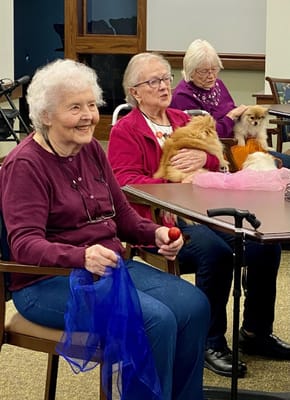 Residents enjoying an activity with therapy dogs