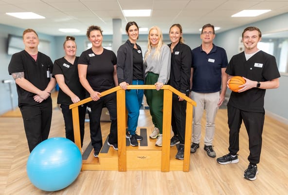 Staff and residents engaging in a group activity in a bright room