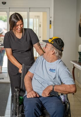 Staff member assisting a resident in a hallway