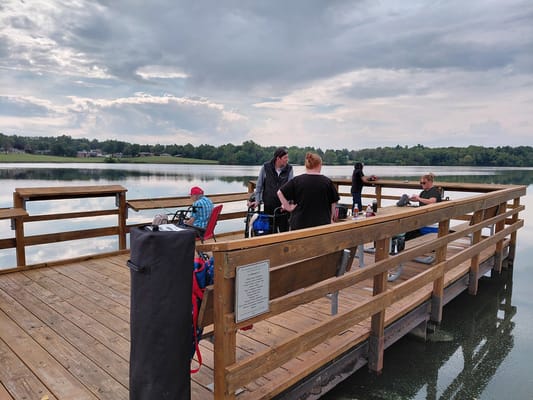 Residents fishing and socializing on a wooden dock