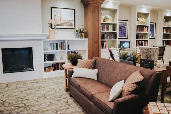 Cozy common area with fireplace and bookshelves