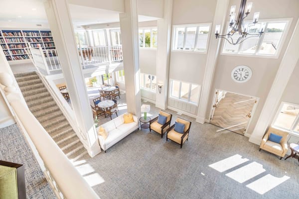 Interior view of a bright common area with seating and bookshelves
