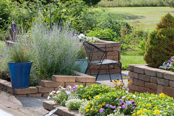 A serene garden area with flowers and seating