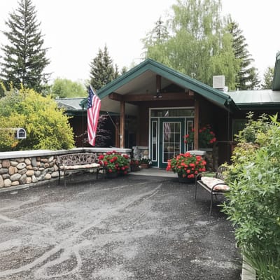 Entrance of a senior care facility with flower beds